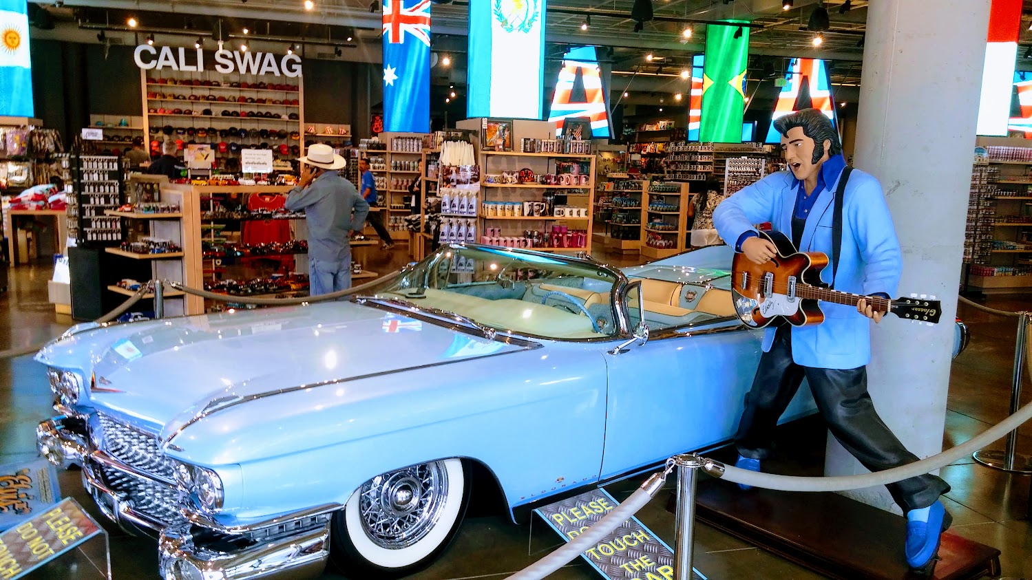 Vintage pink Cadillac displayed on Hollywood Boulevard